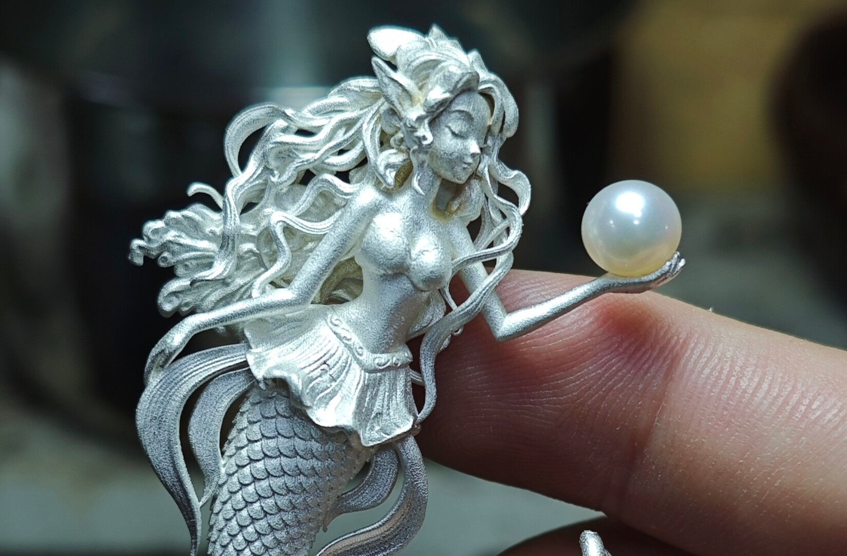Mermaid Hand Holding Pearl Necklace