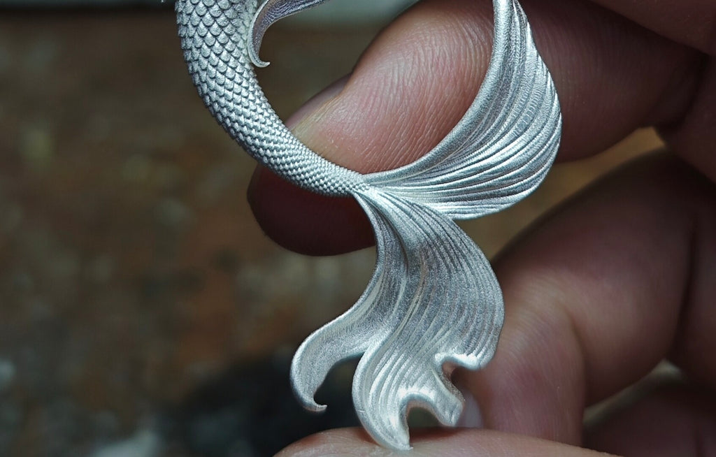 Mermaid Hand Holding Pearl Necklace