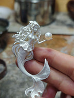 Mermaid Hand Holding Pearl Necklace